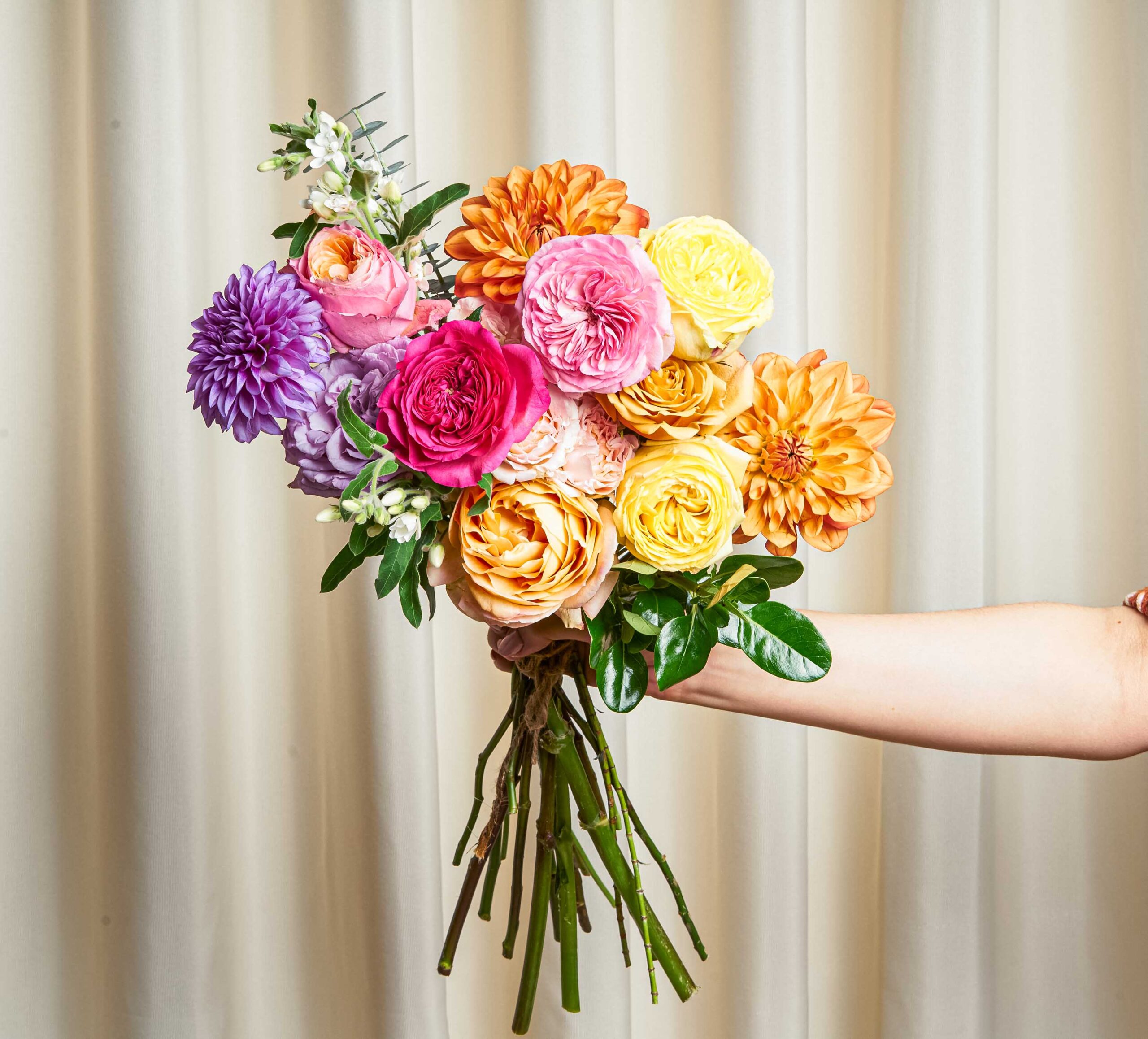 A colorful bouquet of roses and dahlias