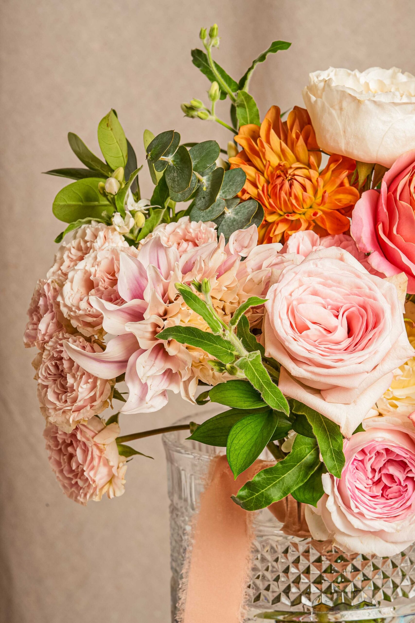 Bouquet of pink roses and orange dahlias